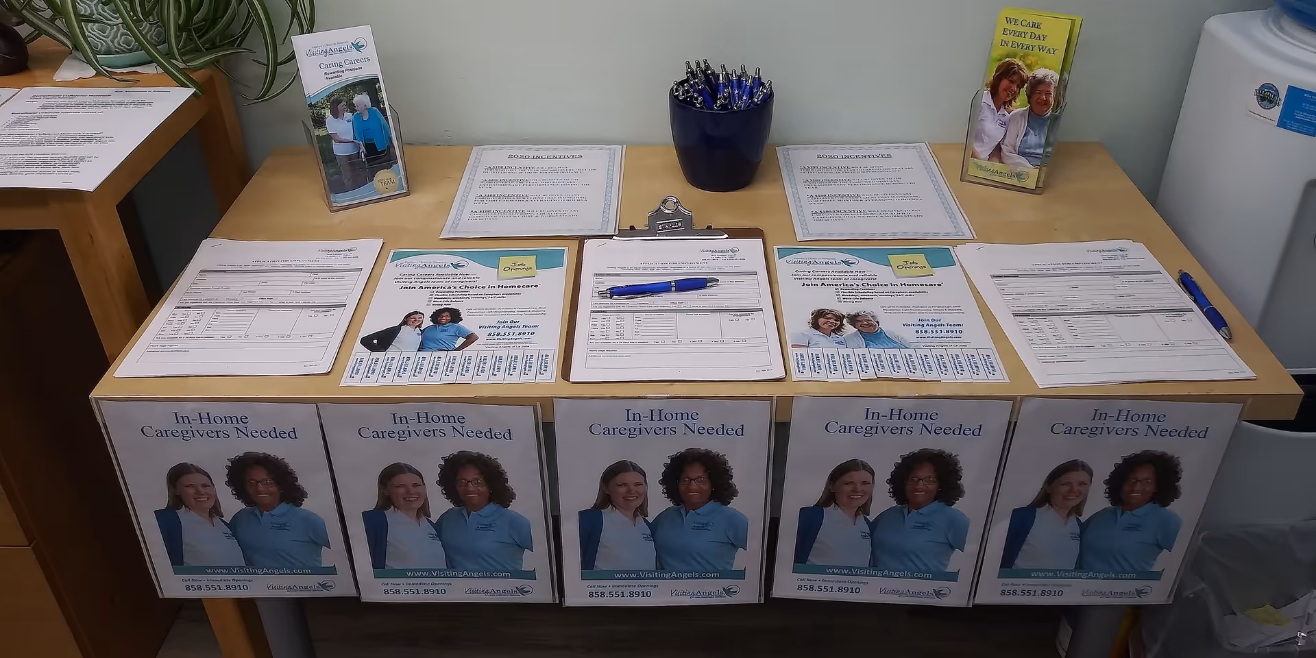 Interior reception desk with caregiver brochures and forms at Visiting Angels Senior Home Care.