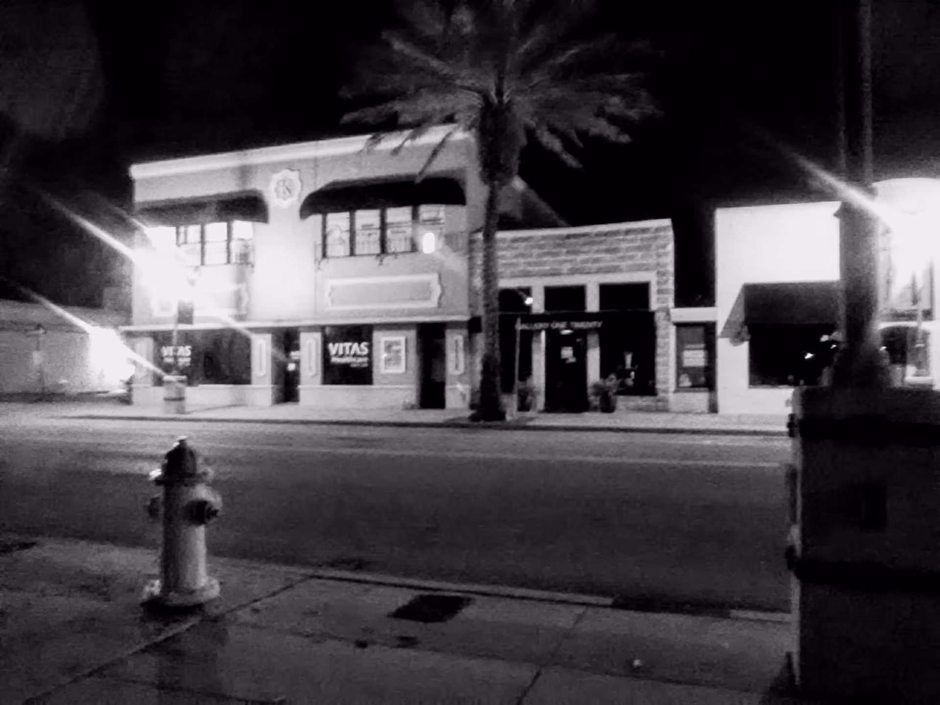 Nighttime street view of a building front labeled VITAS Healthcare.