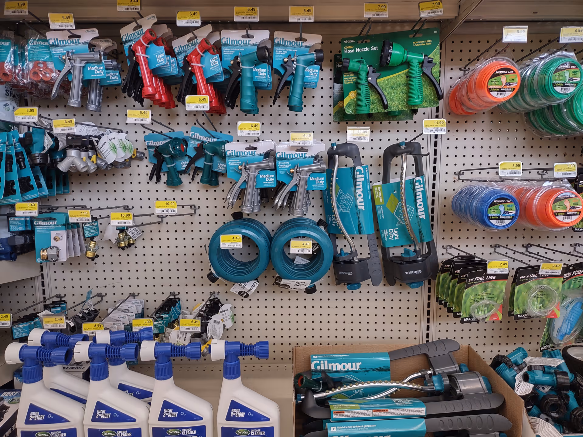 Store aisle with organized hoses, nozzles, reels, and cleaning tools.