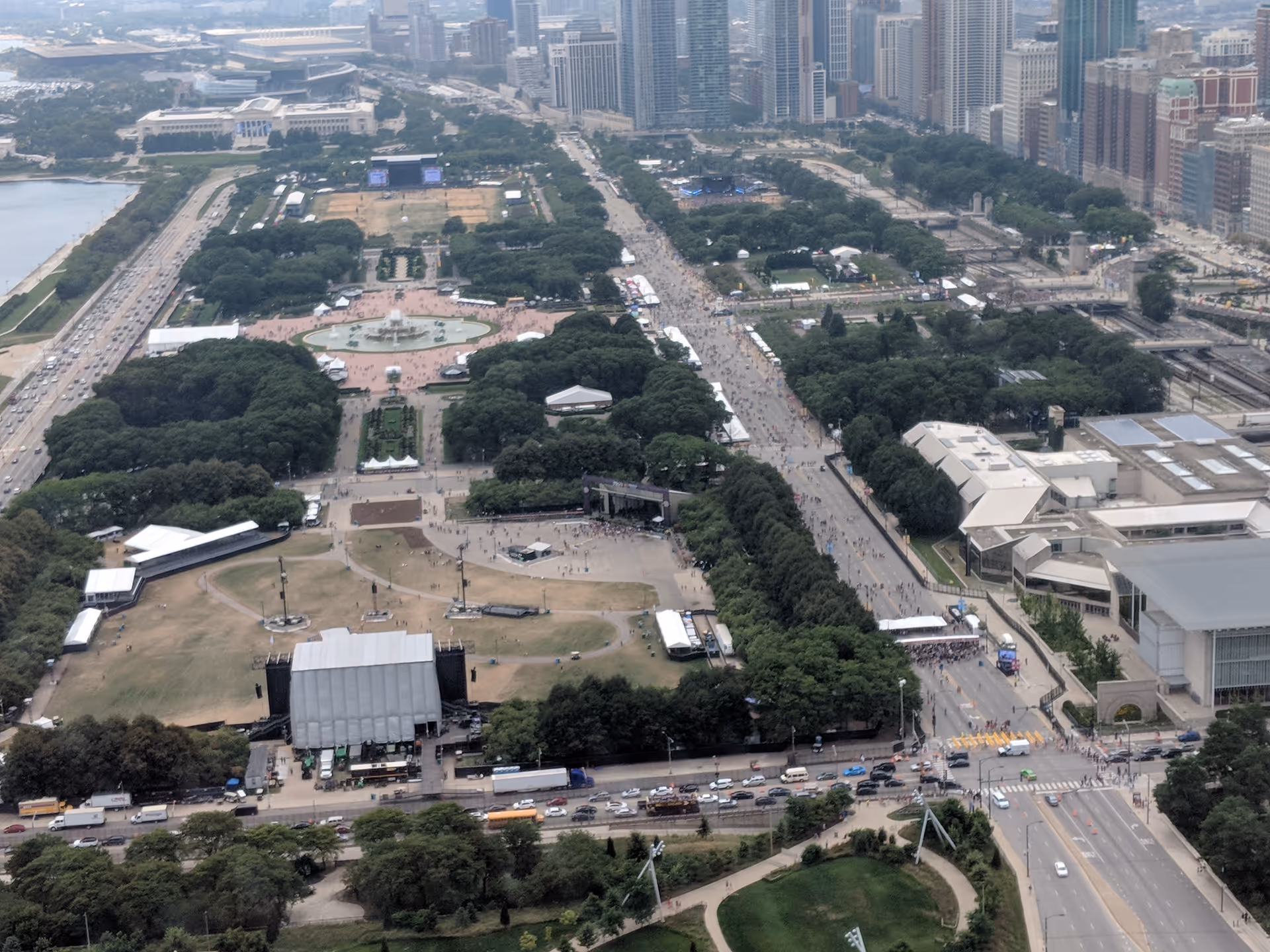 Aerial view of a large city park surrounded by roads and tall buildings.