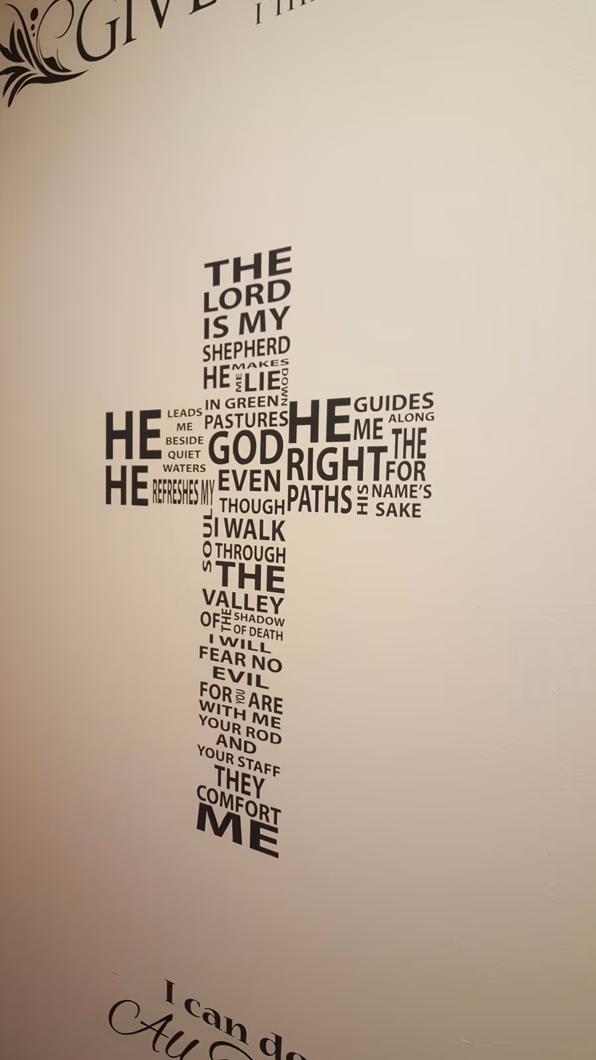 Interior wall features a cross-shaped typographic Bible verse artwork in a senior living facility.