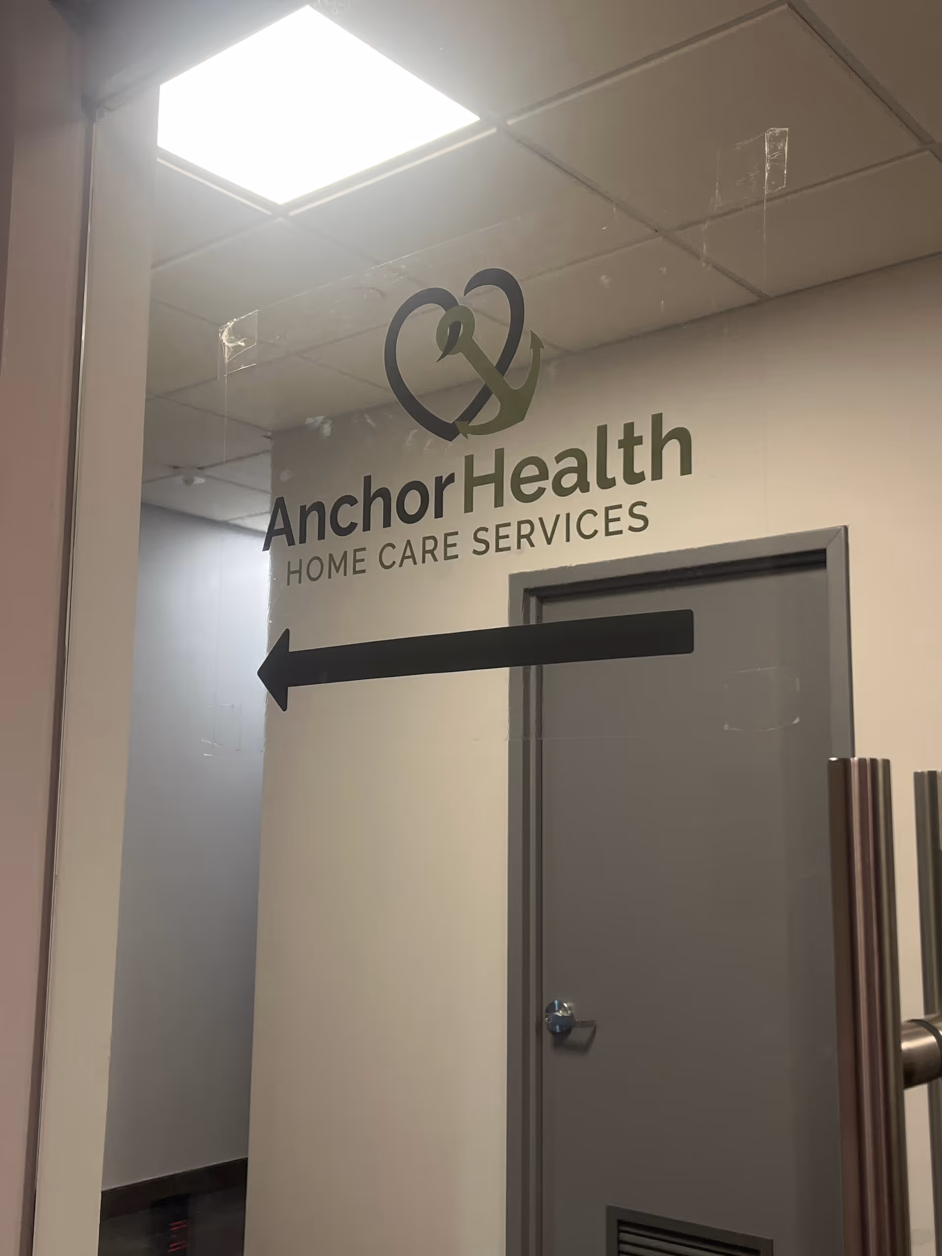 Interior hallway showing Anchor Health Home Care Services sign and left arrow
