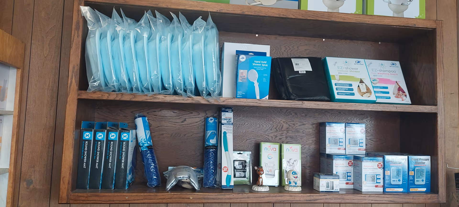 Wooden shelf unit stocked with medical supplies and boxes.