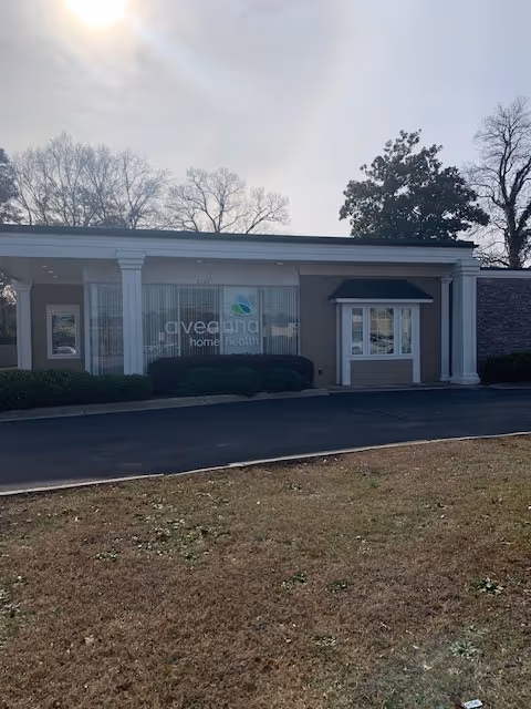 Exterior view of Aveanna Home Health building with entrance and signage.