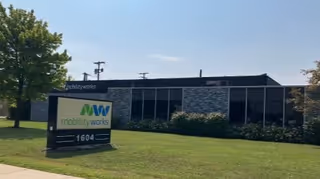 Exterior view of MobilityWorks building with lawn sign in front of the facility.