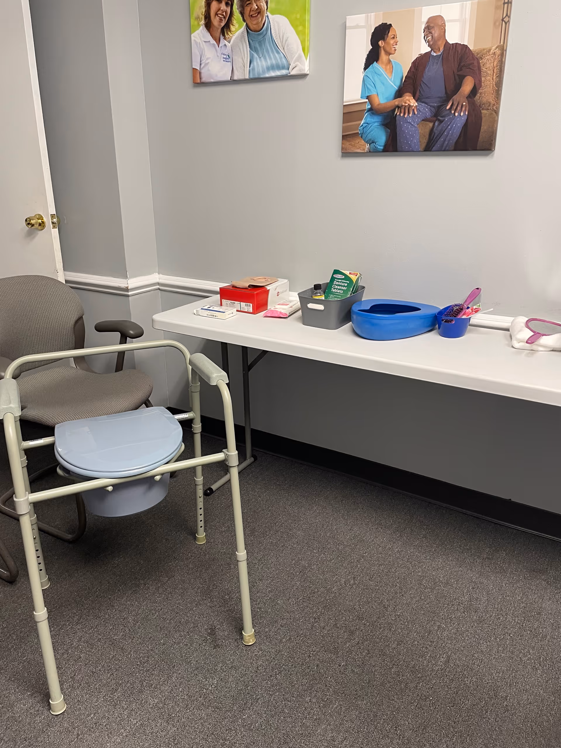 A medical examination corner with a walker, table, and medical supplies in a clinic.