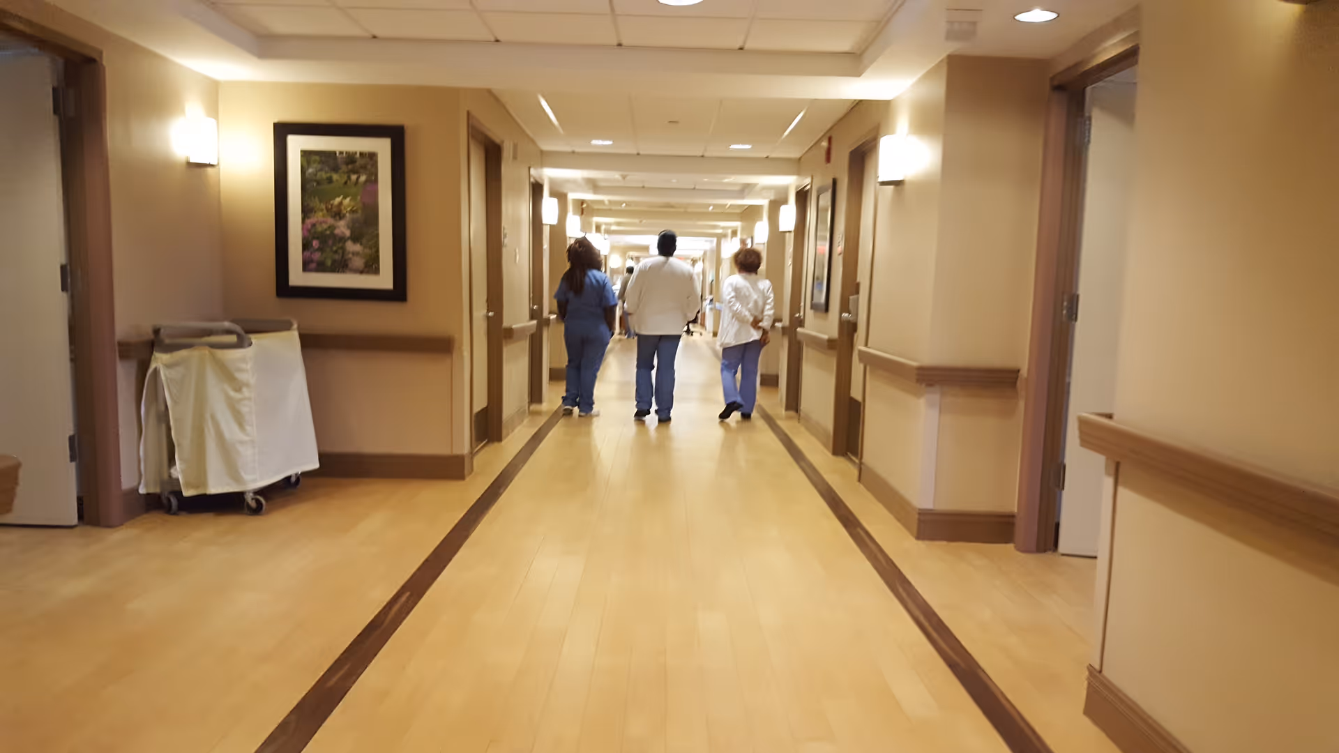 Interior corridor at Miami Jewish Health with staff walking away.