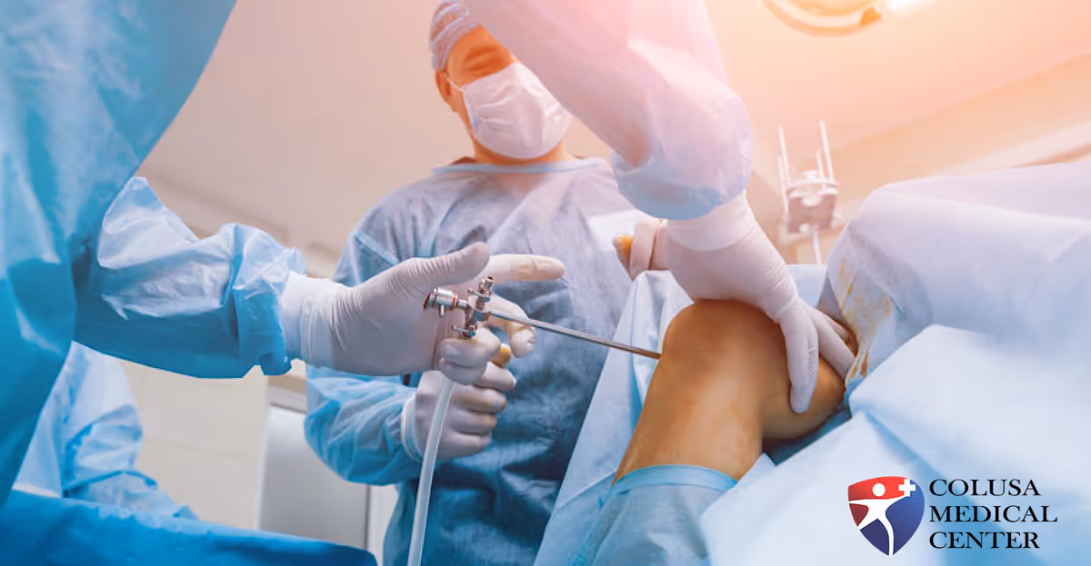 Surgeons operate on a patient's knee in an operating room.
