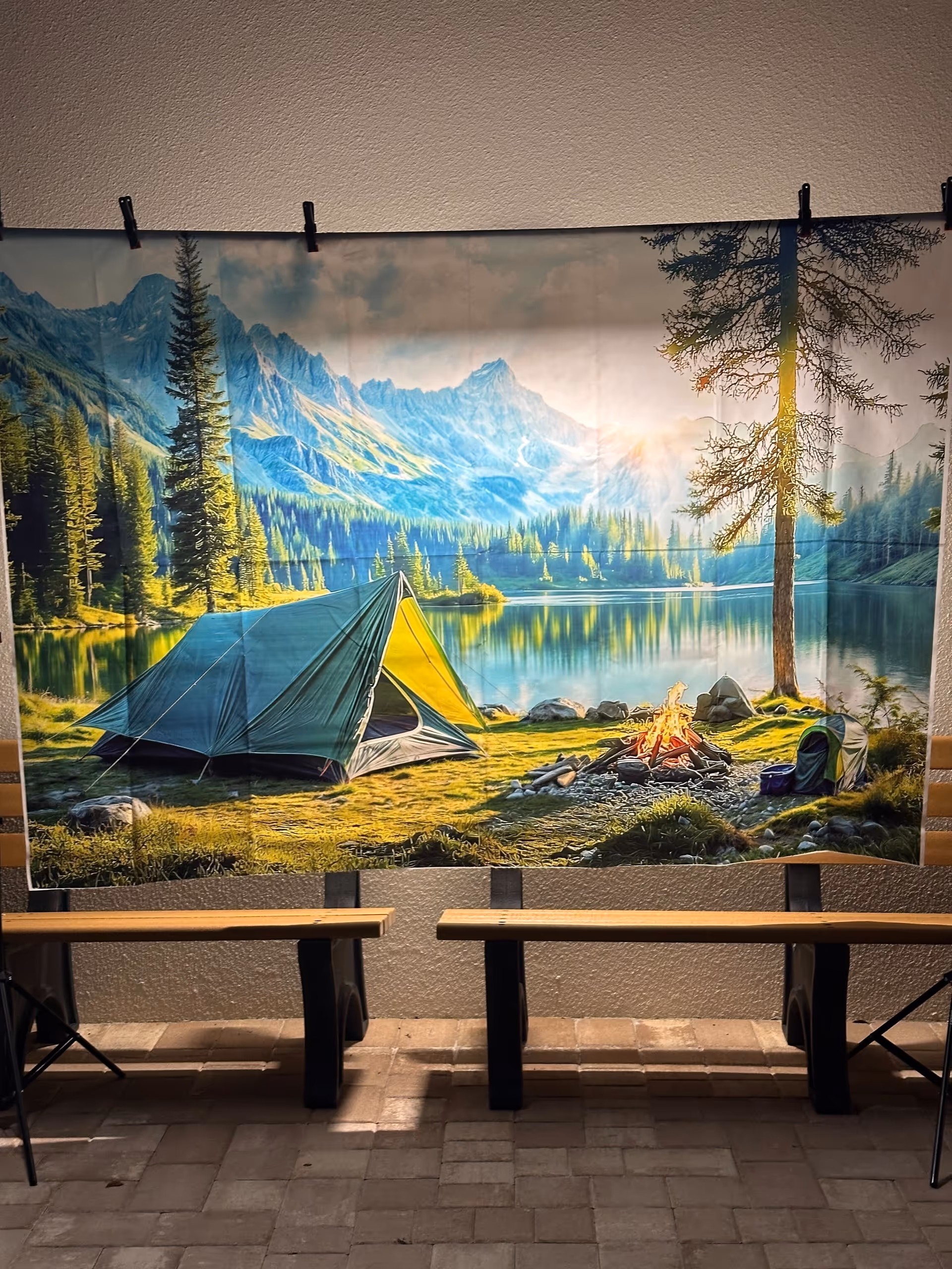 Interior hallway with a large outdoor landscape mural showing a tent and campfire.