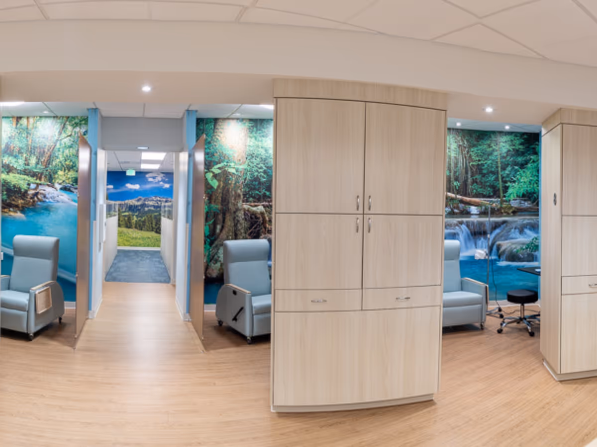 Hallway featuring wood cabinets, blue recliners, and nature-themed wall murals.