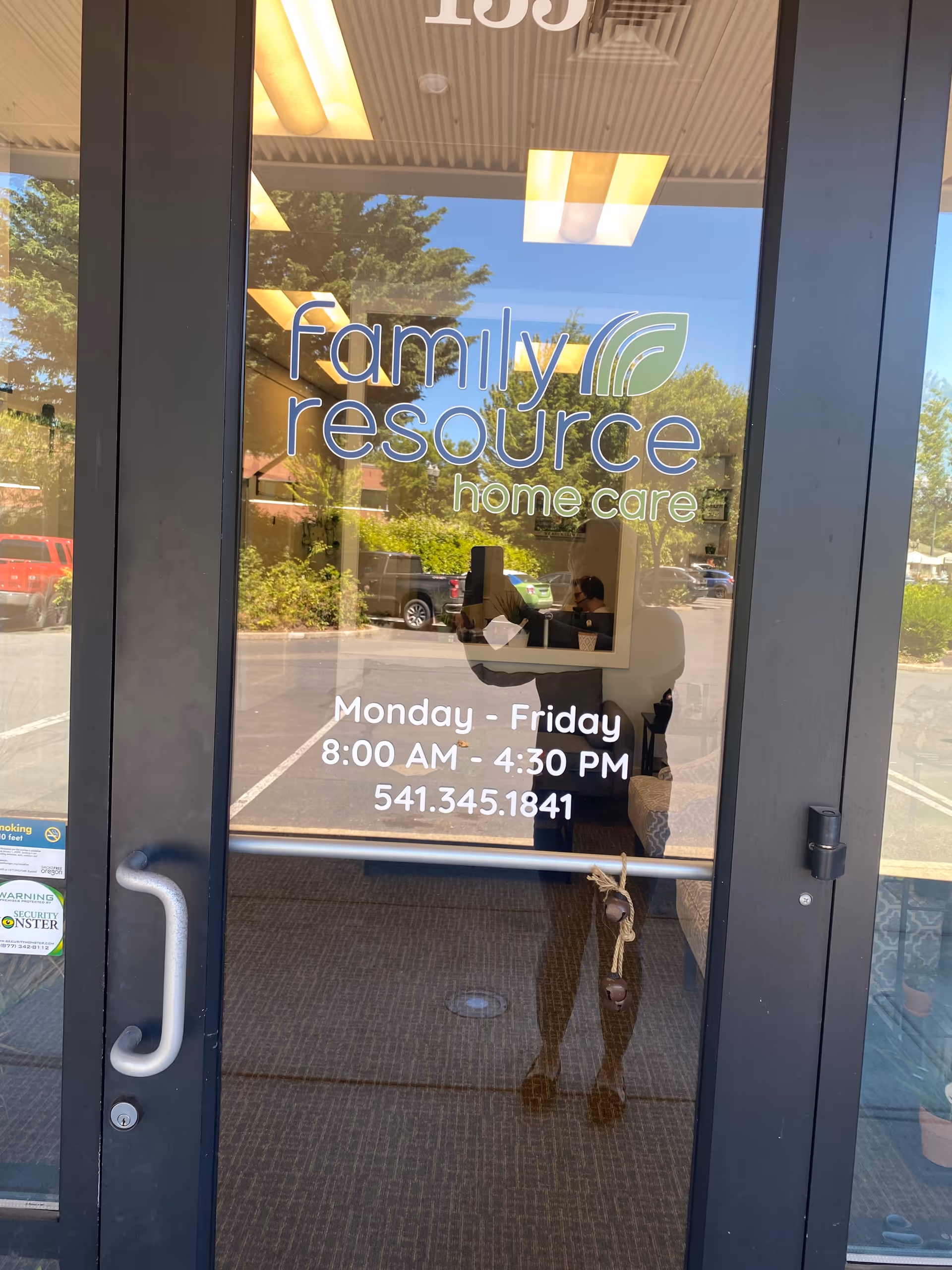 Glass entrance door shows Family Resource Home Care logo and business hours.