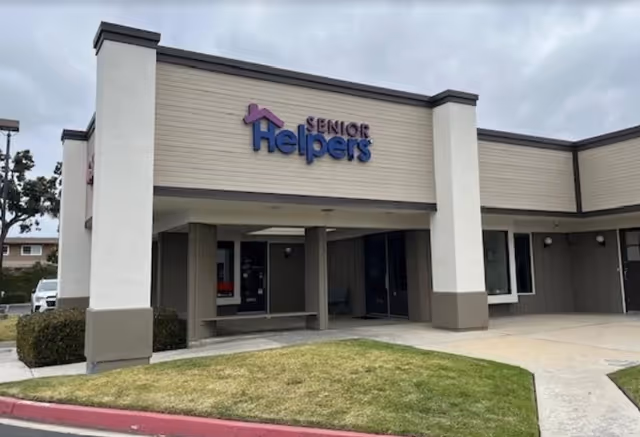 Exterior view of a Senior Helpers facility facade with entrance under a covered walkway.