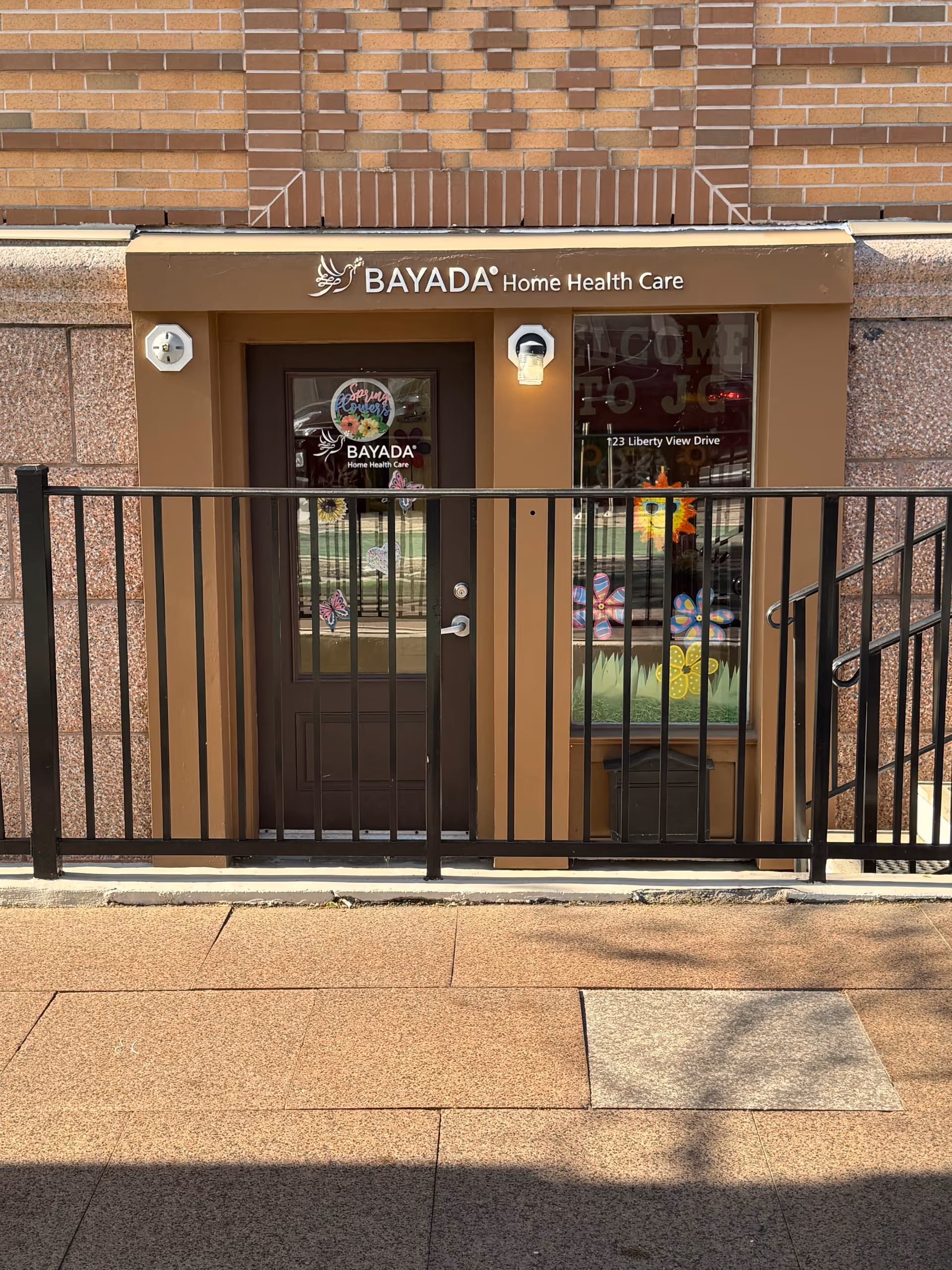 Front entrance of BAYADA Home Health Care facility with brown doors and railing