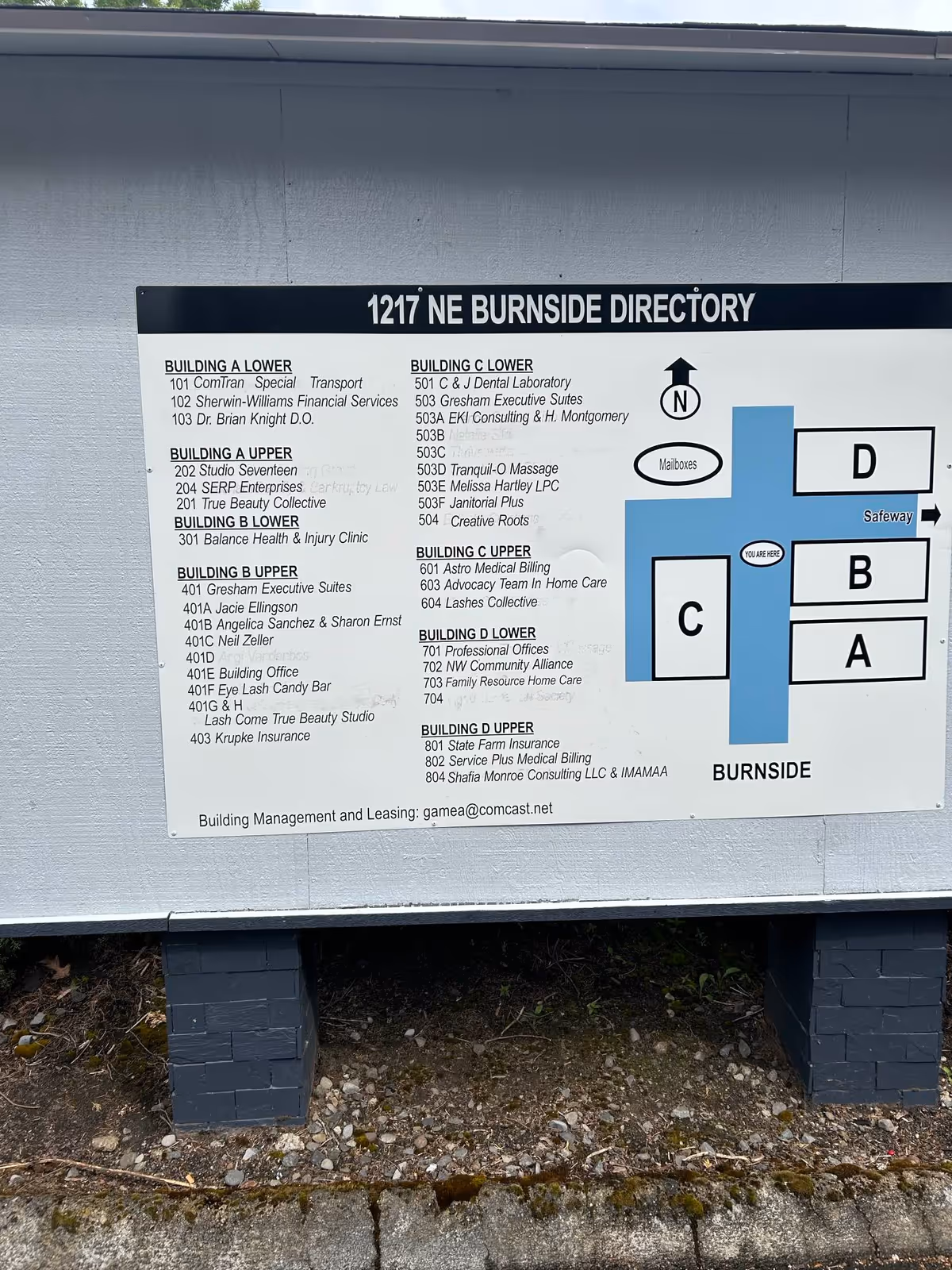 Exterior building directory sign listing suites and tenant names.