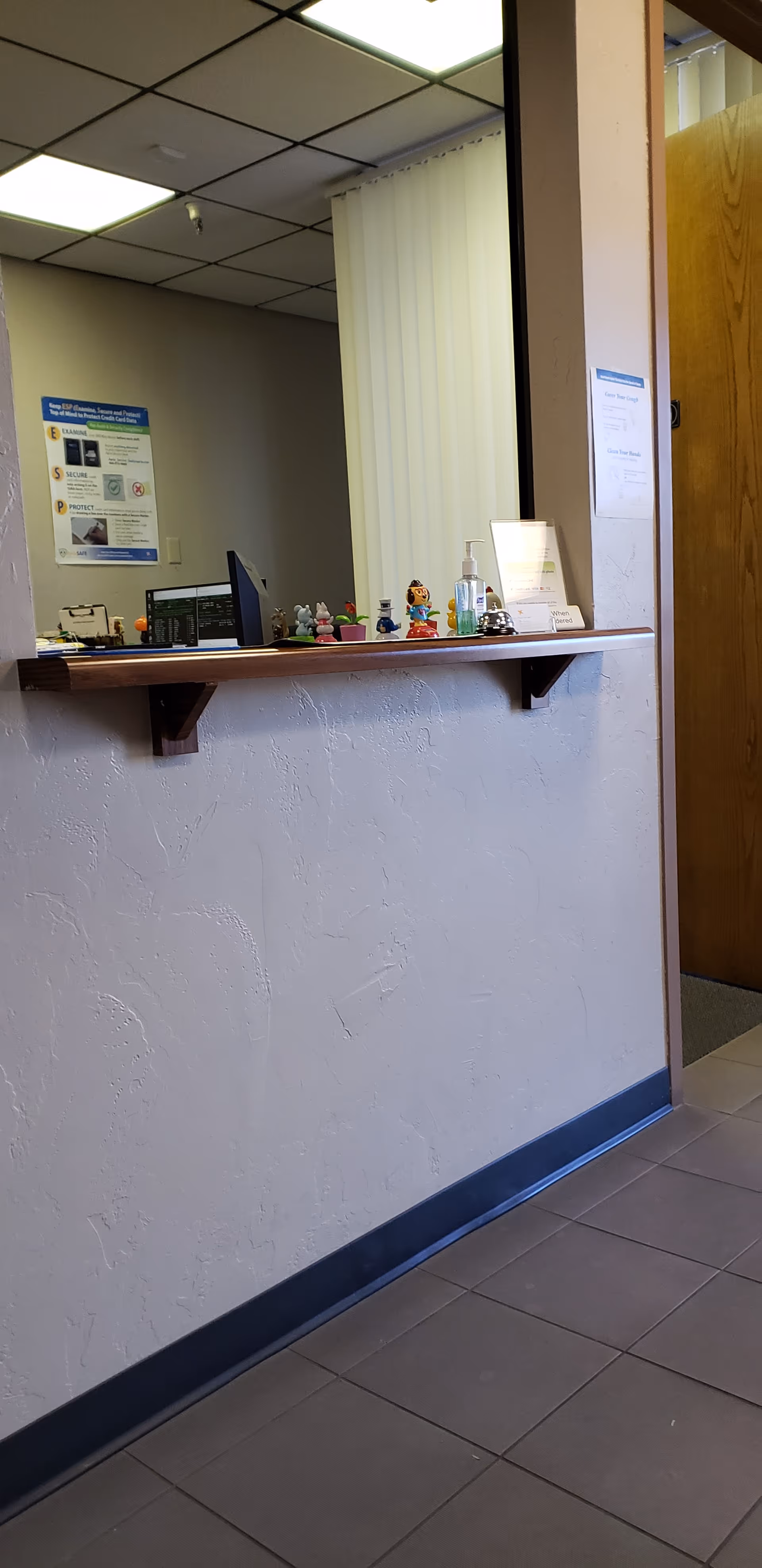 Reception counter inside a senior living facility with a computer and small decorations.