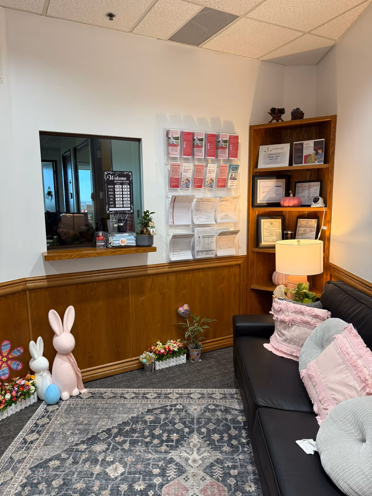 Interior waiting area with a sofa, bunny decorations, and brochure display.