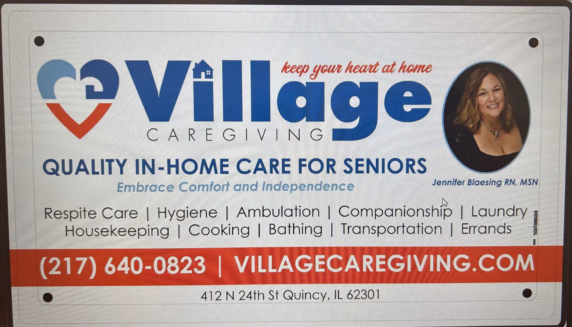A Village Caregiving sign featuring logo, slogan, and an oval portrait.