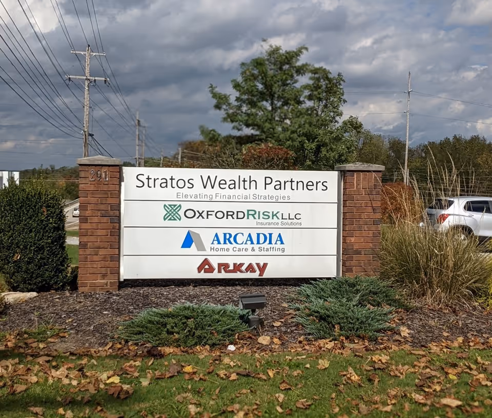 Outdoor sign display for Arcadia Home Care and Staffing with Oxford Risk and Stratos Wealth Partners.