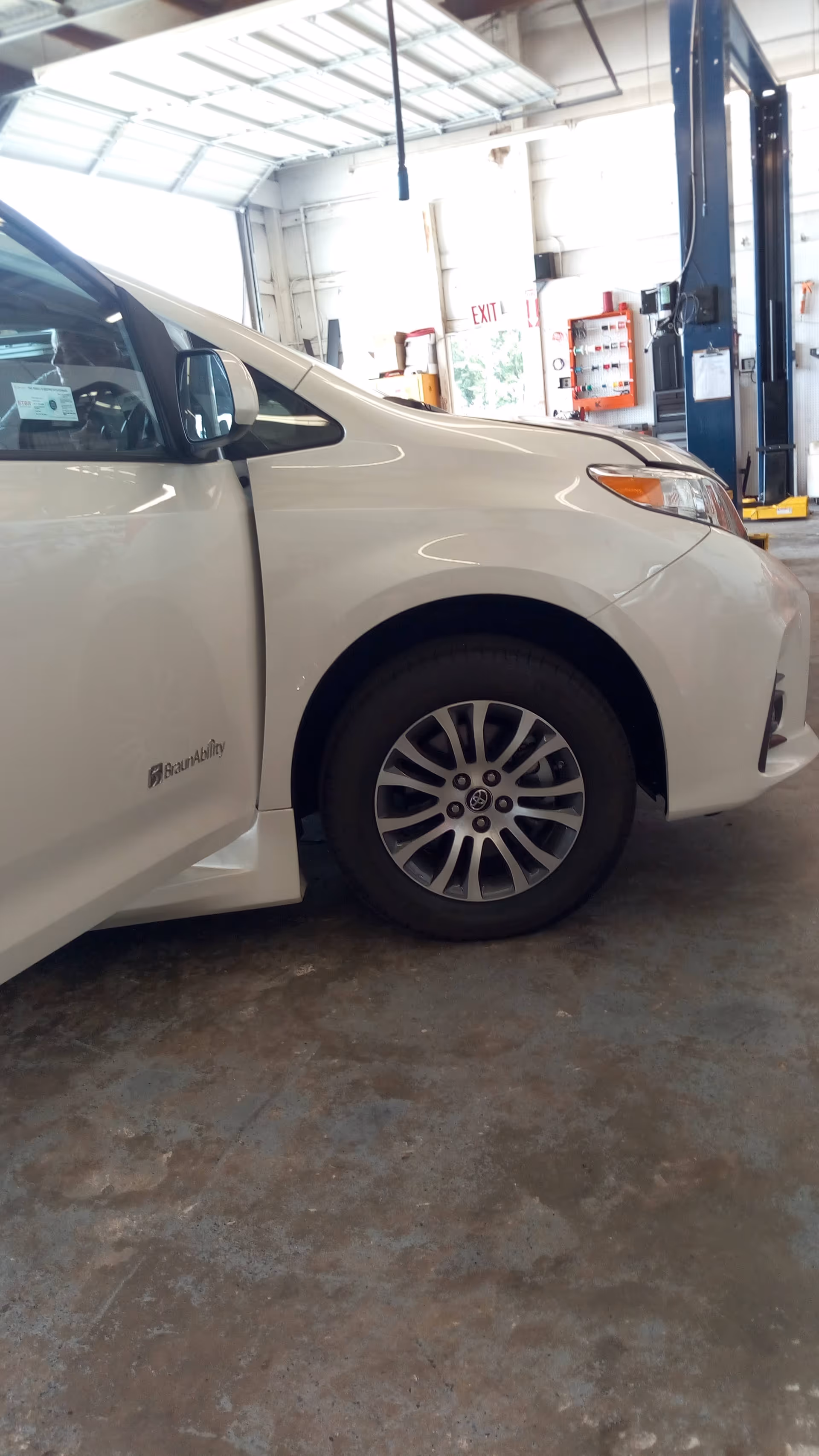 White mobility van inside a service bay at MobilityWorks facility.