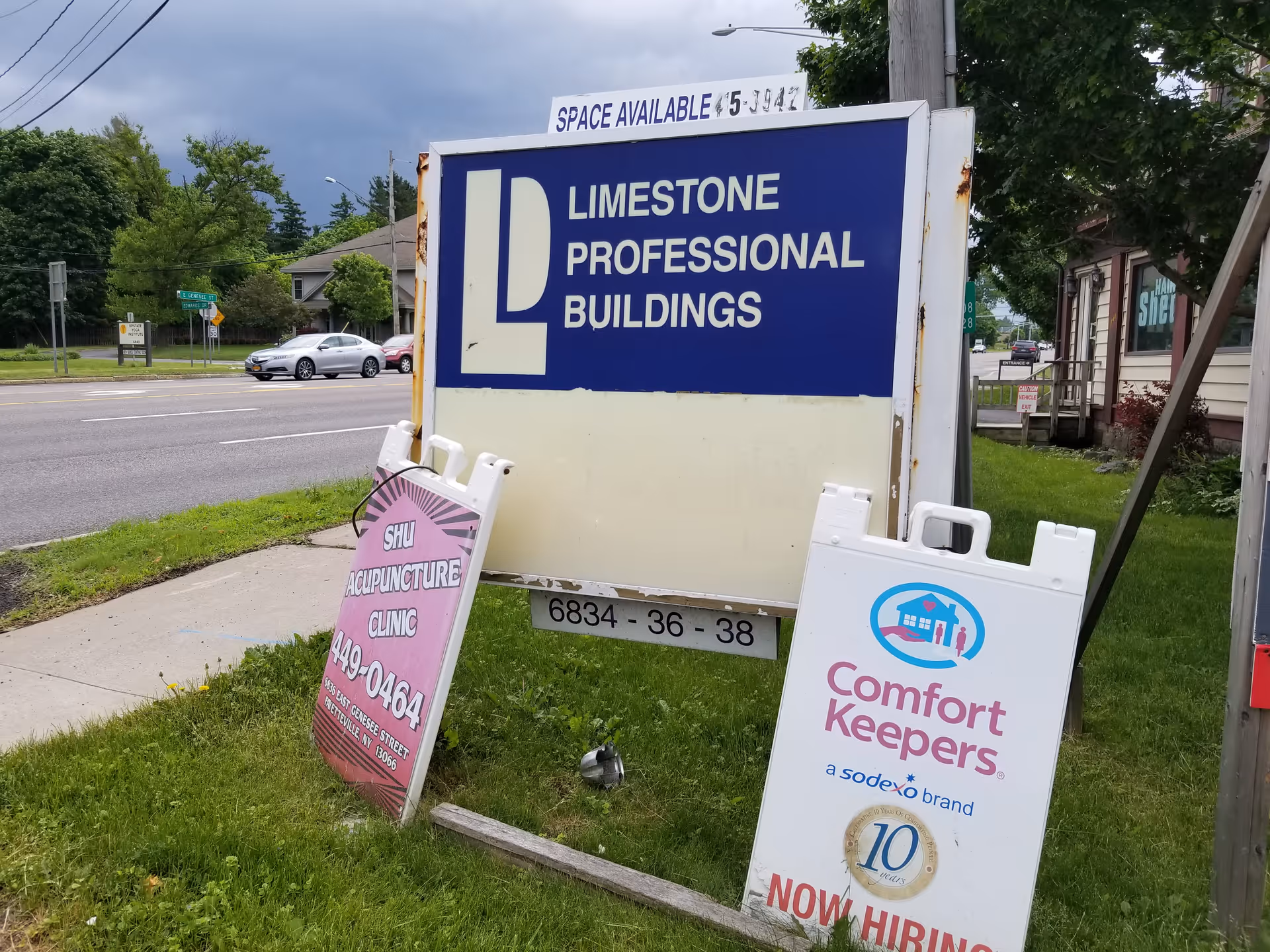 Exterior street scene with large Limestone Professional Buildings sign and Comfort Keepers sign.