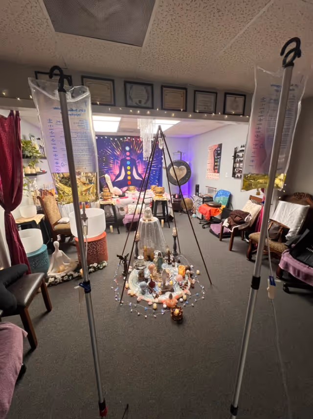 Indoor therapy room with IV poles, seating, and a crystal centerpiece.