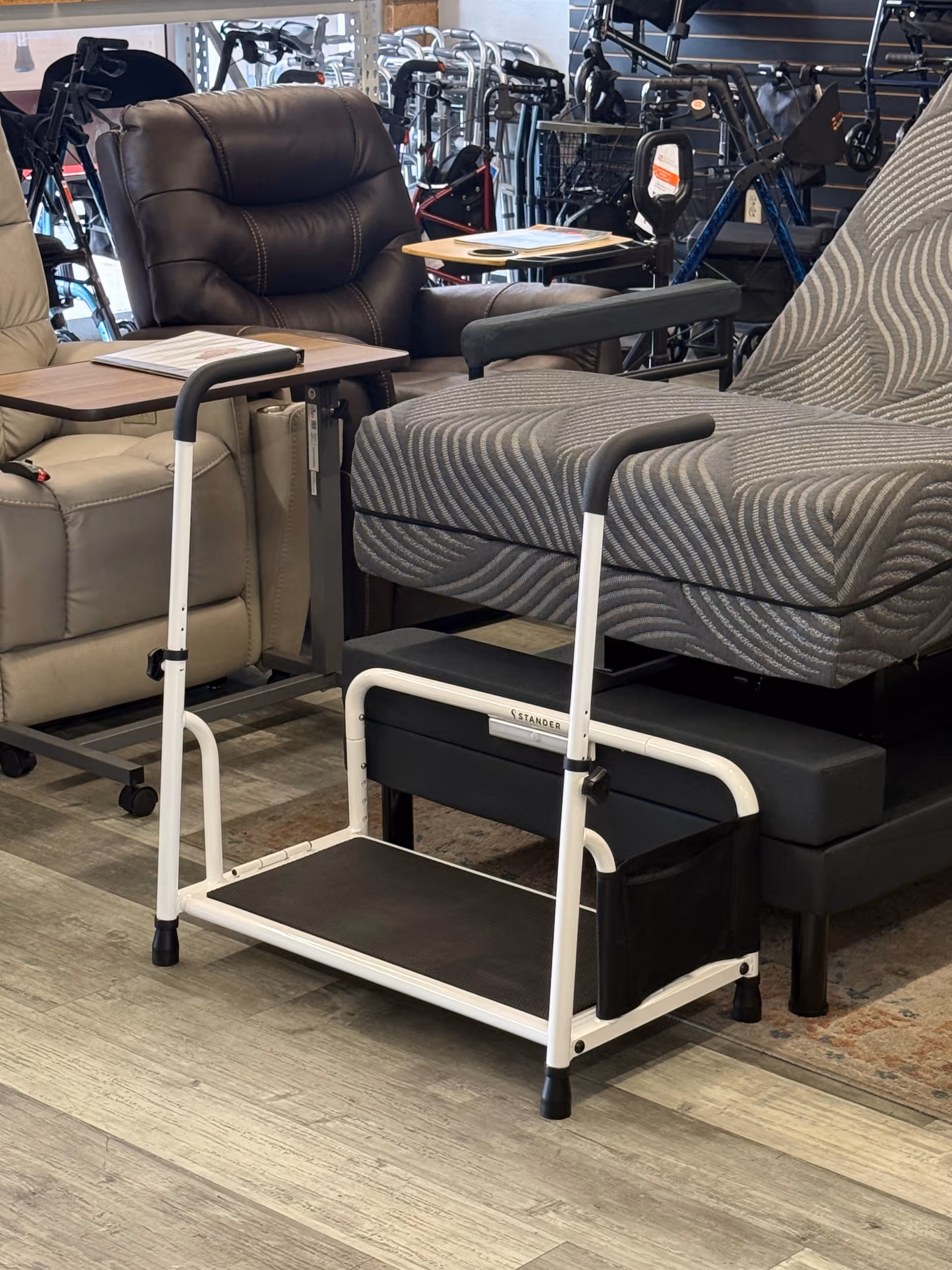 Showroom interior with recliners, chairs, and a white wheeled step stool.