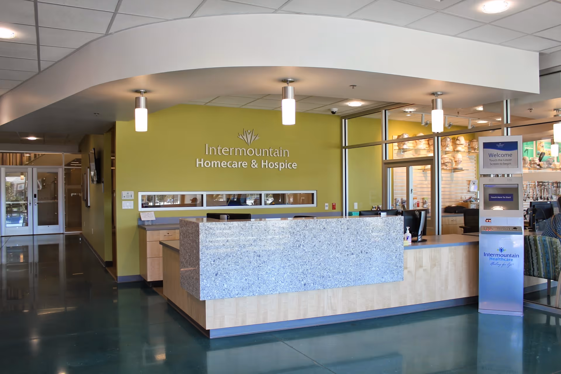 Reception area at Intermountain Homecare & Hospice with curved ceiling and lime-green wall.