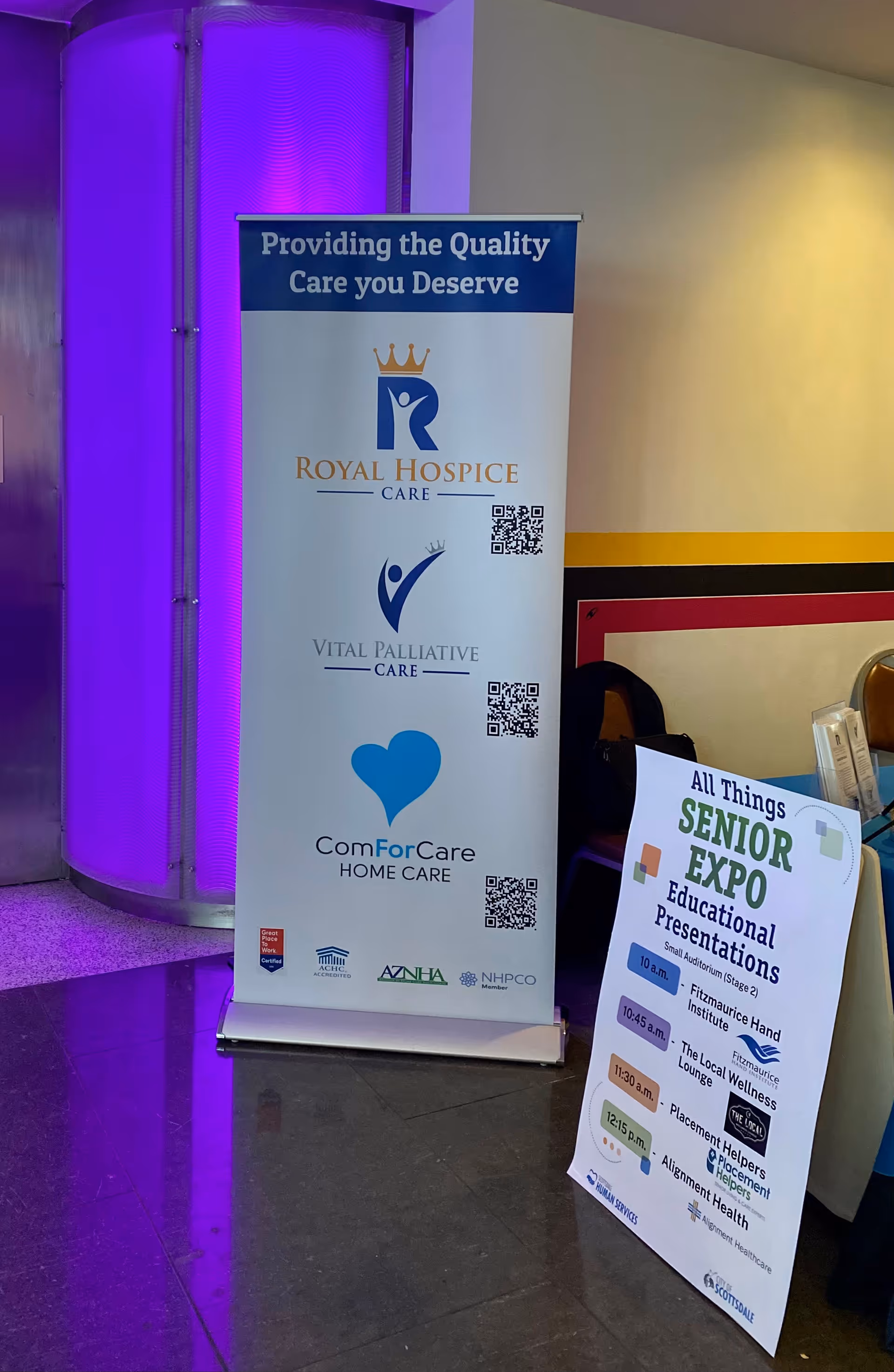 Interior lobby with banners for ComForCare Home Care and a Senior Expo sign.