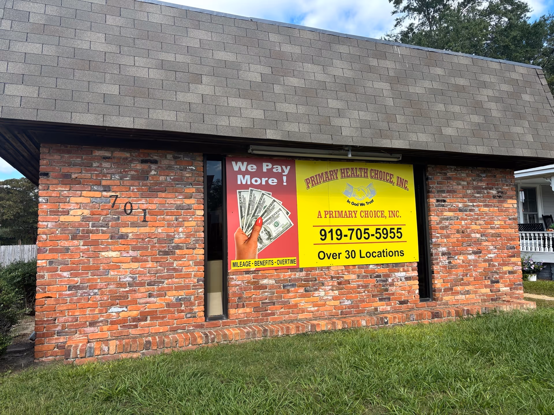 Brick building with a large yellow Primary Health Choice sign on the front.