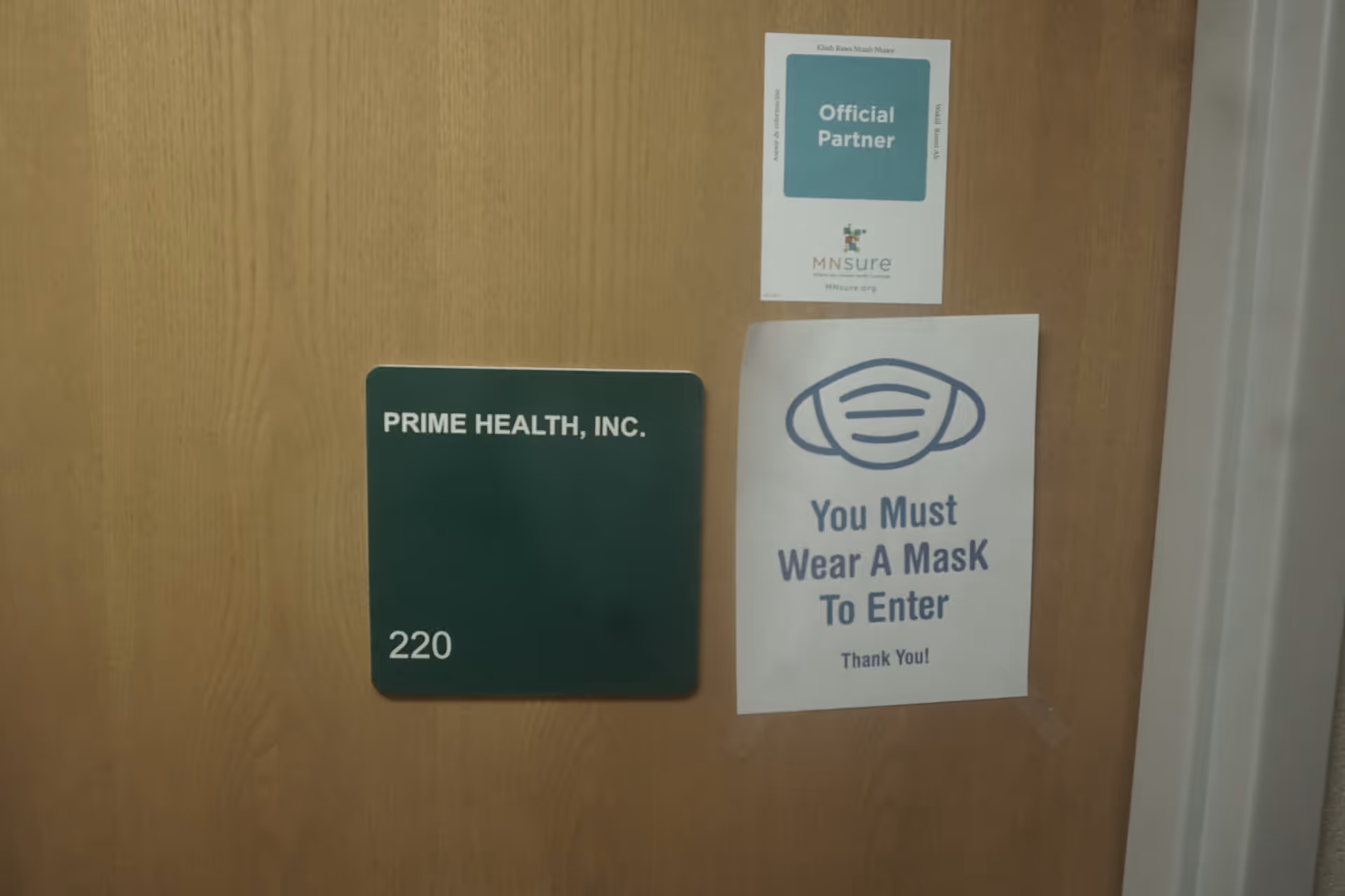 Door with Prime Health sign, room 220, and You Must Wear a Mask to Enter notice.