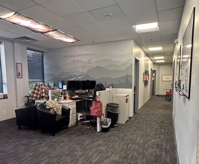 Open interior BAYADA Home Health office with desks, chairs, and a wall mural.