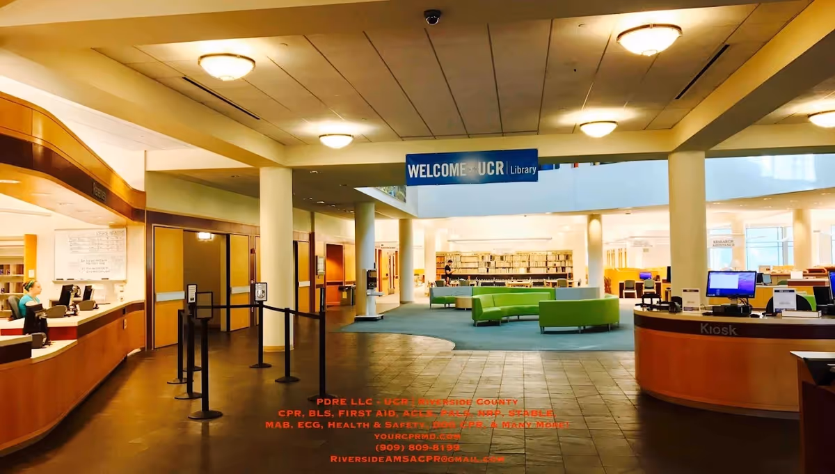 Interior lobby of a senior living facility with a library, seating, and check-in desks.