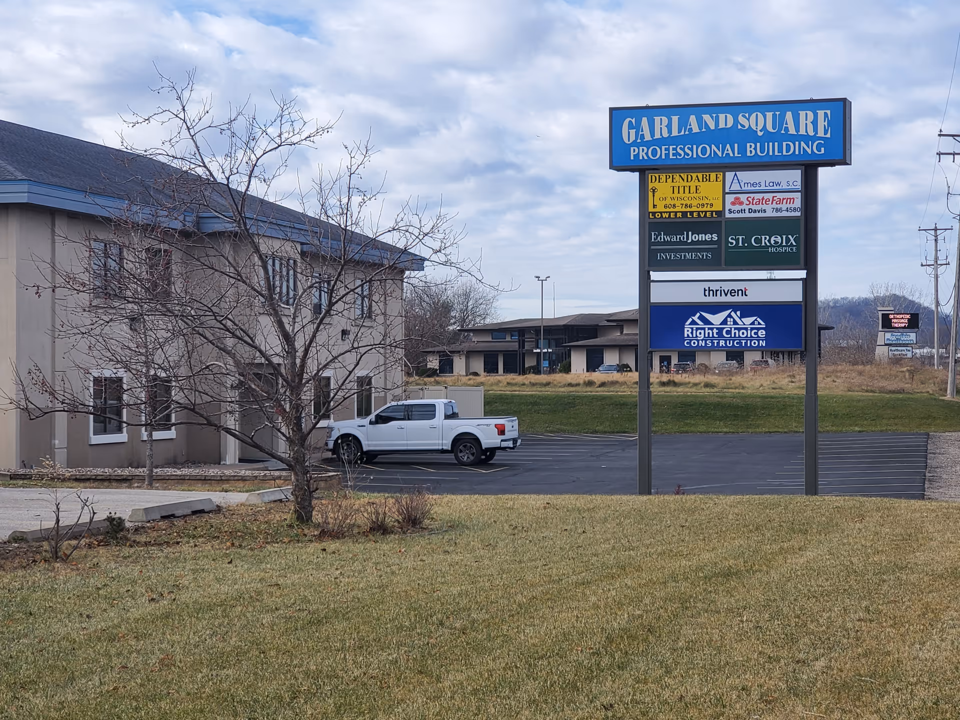 Exterior view of a facility with Garland Square sign and hospice branding