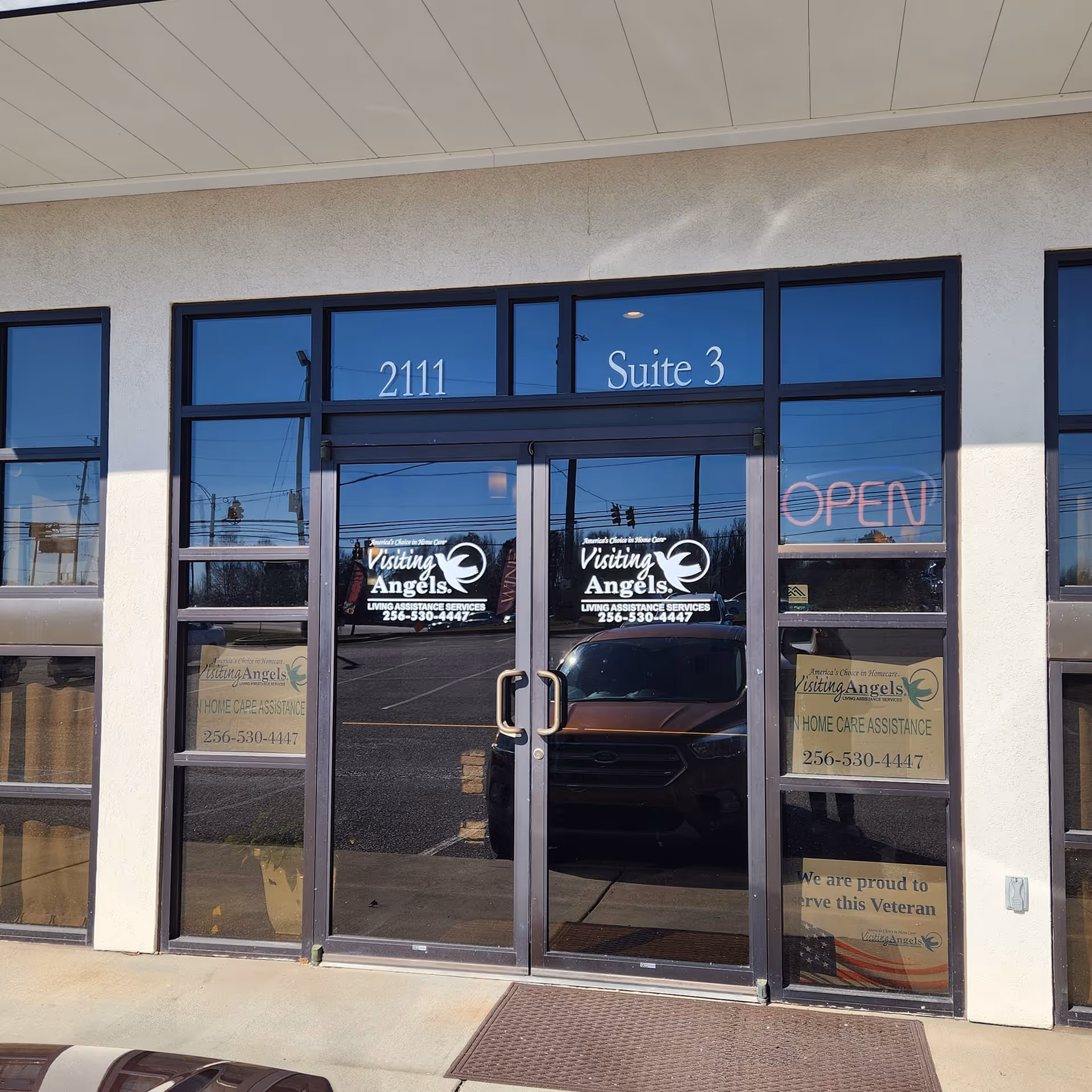 Exterior view of Visiting Angels storefront with Suite 3 entrance and open sign