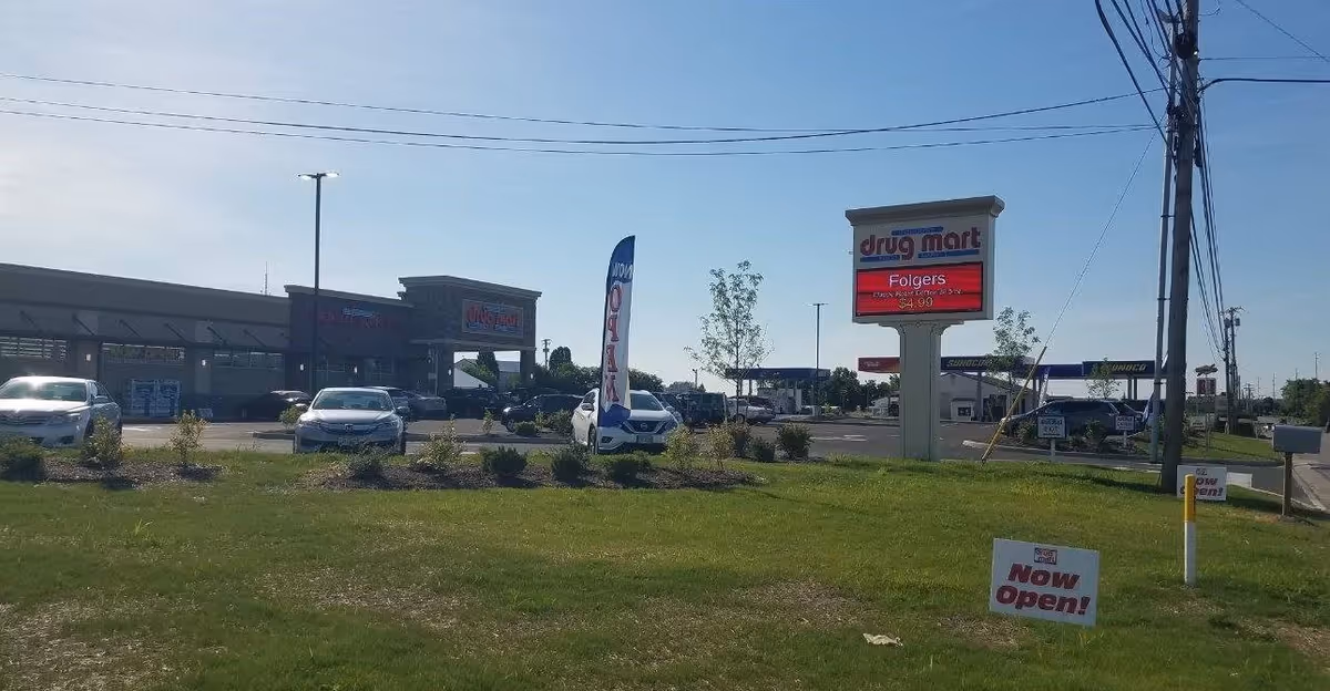 Front exterior of Discount Drug Mart with parking lot and signage.