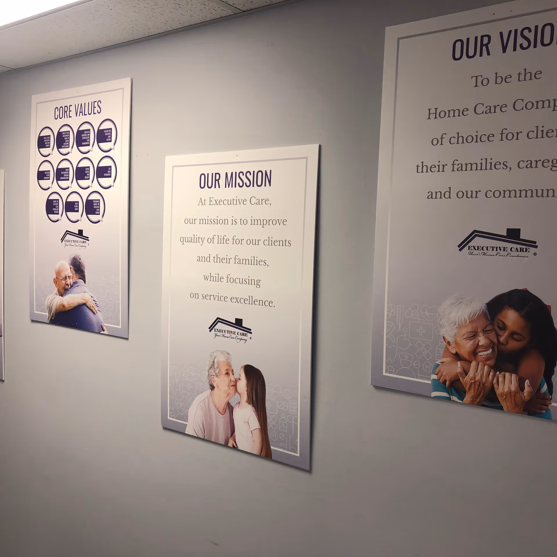 Interior hallway with three framed posters displaying our mission, core values, and vision.