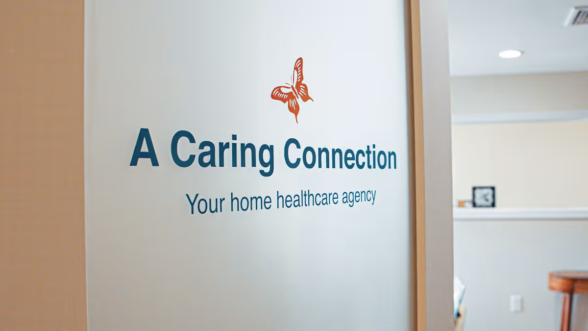 Indoor wall sign A Caring Connection with butterfly logo