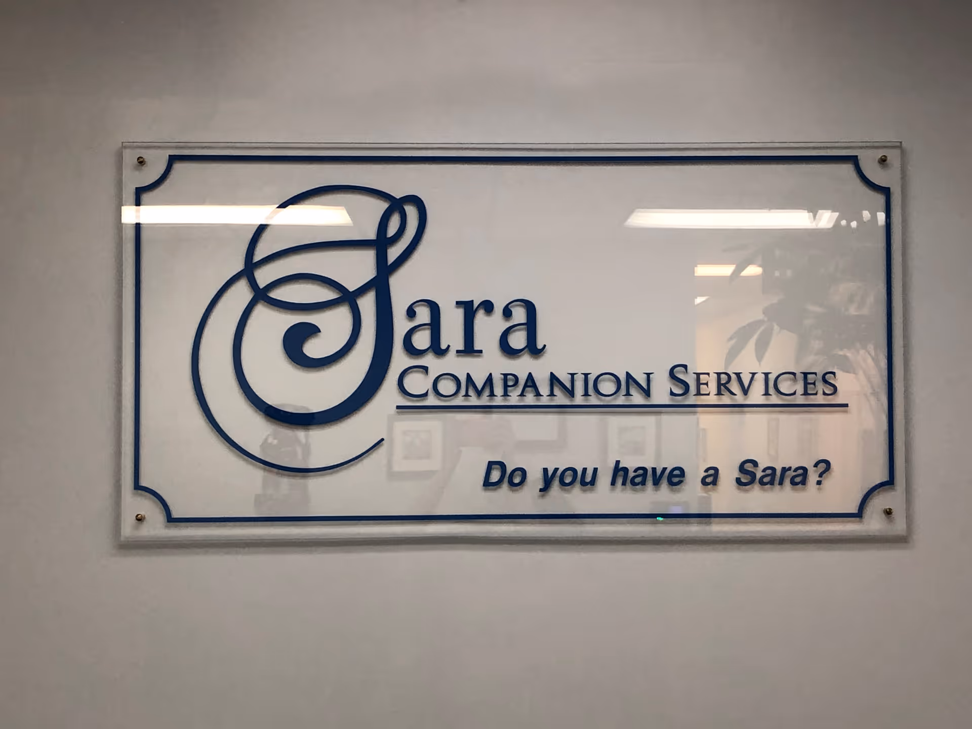 Indoor wall sign reads Sara Companion Services with slogan Do you have a Sara?