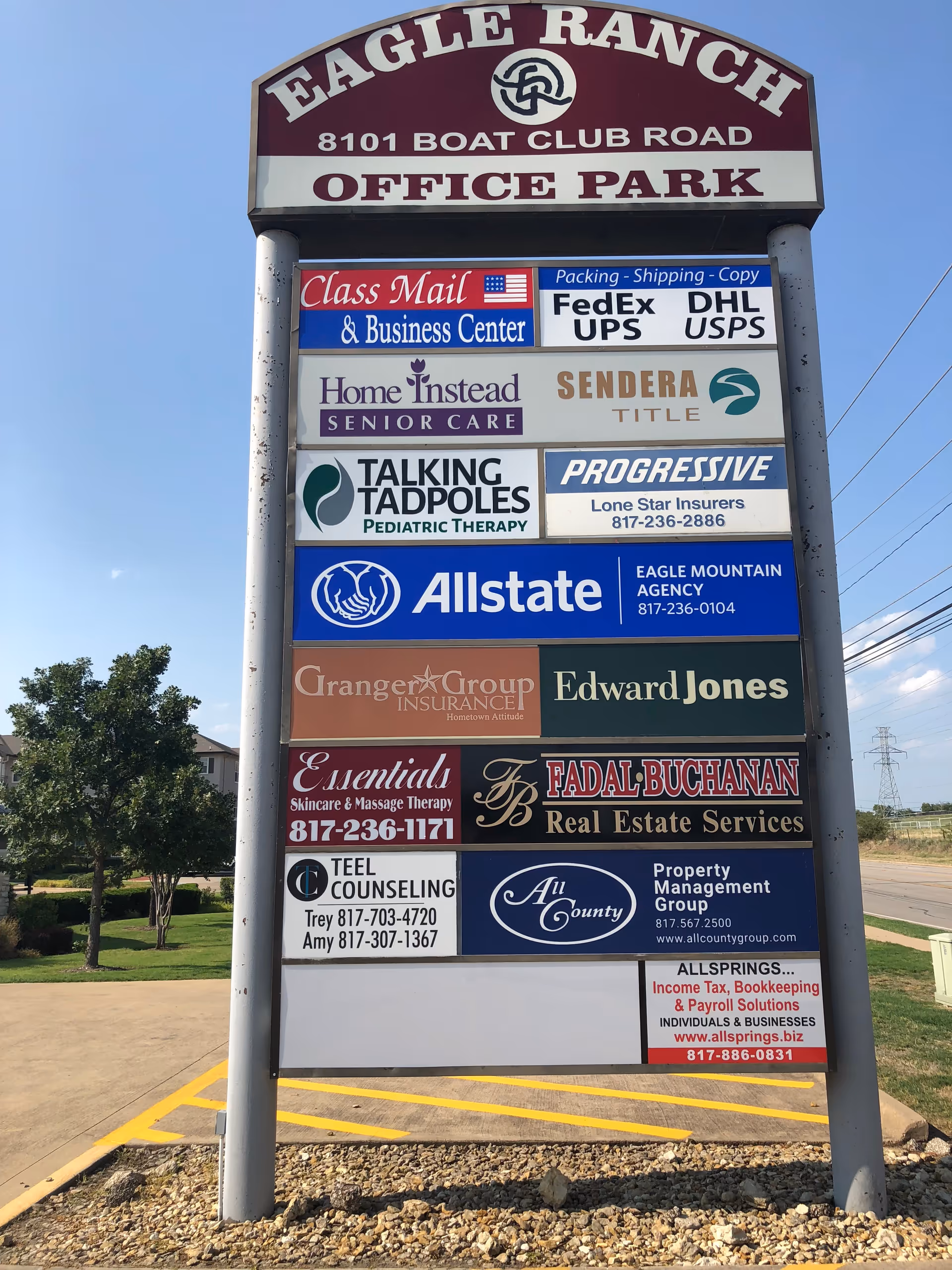 Tall outdoor signboard for Eagle Ranch Office Park displaying multiple business tenants, including Home Instead.