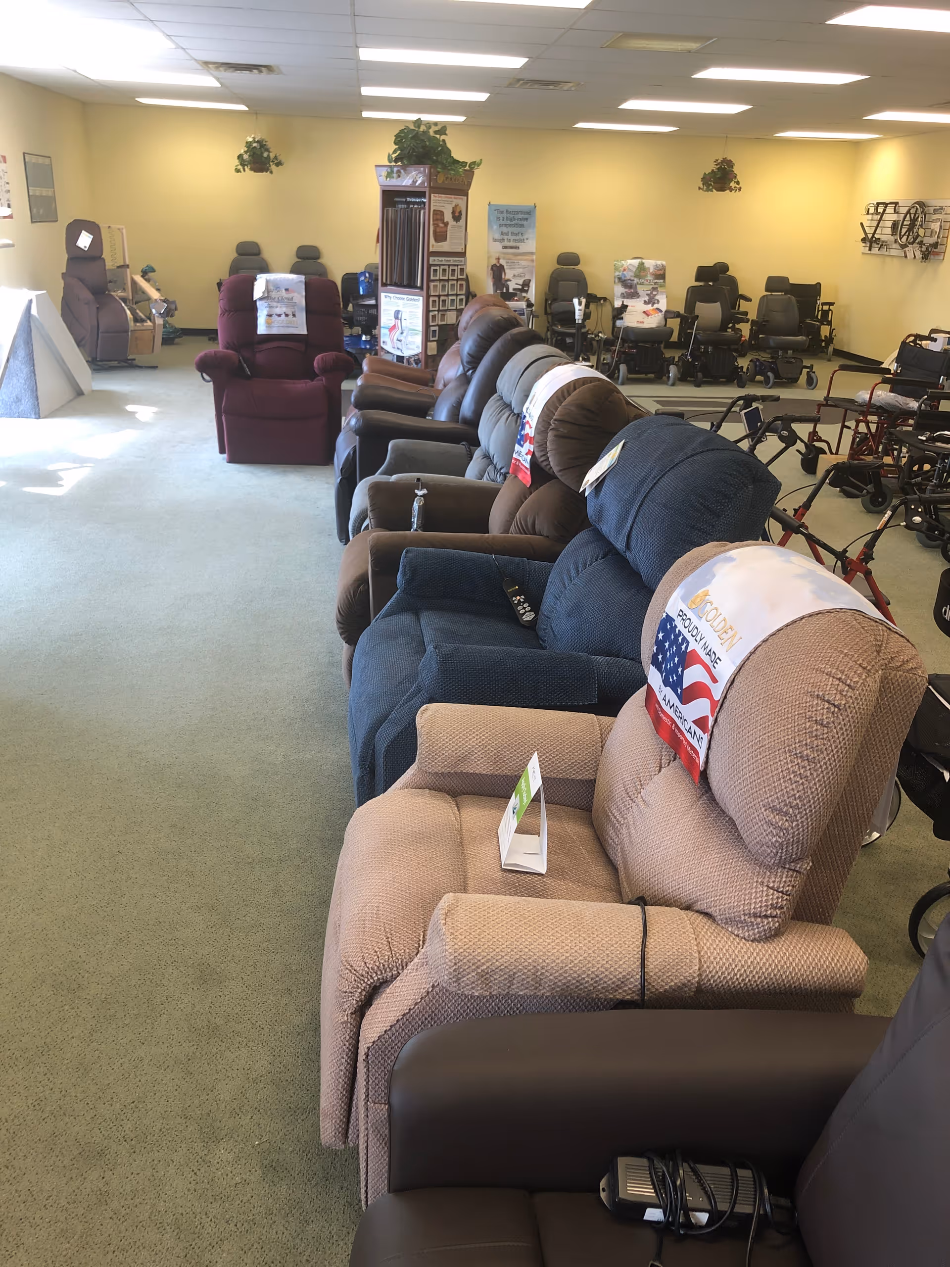 Interior showroom with lined recliners, scooters, and medical chairs in a senior facility.