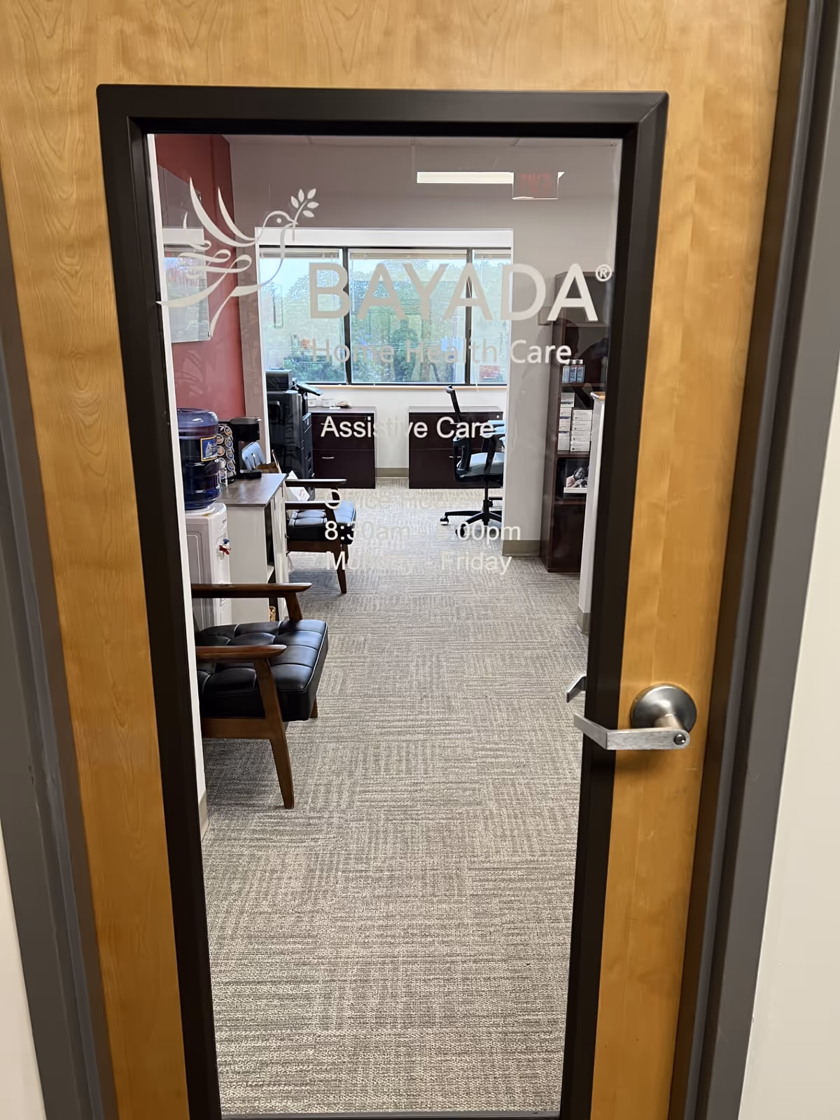Interior office area behind a glass door labeled BAYADA Assistive Care.