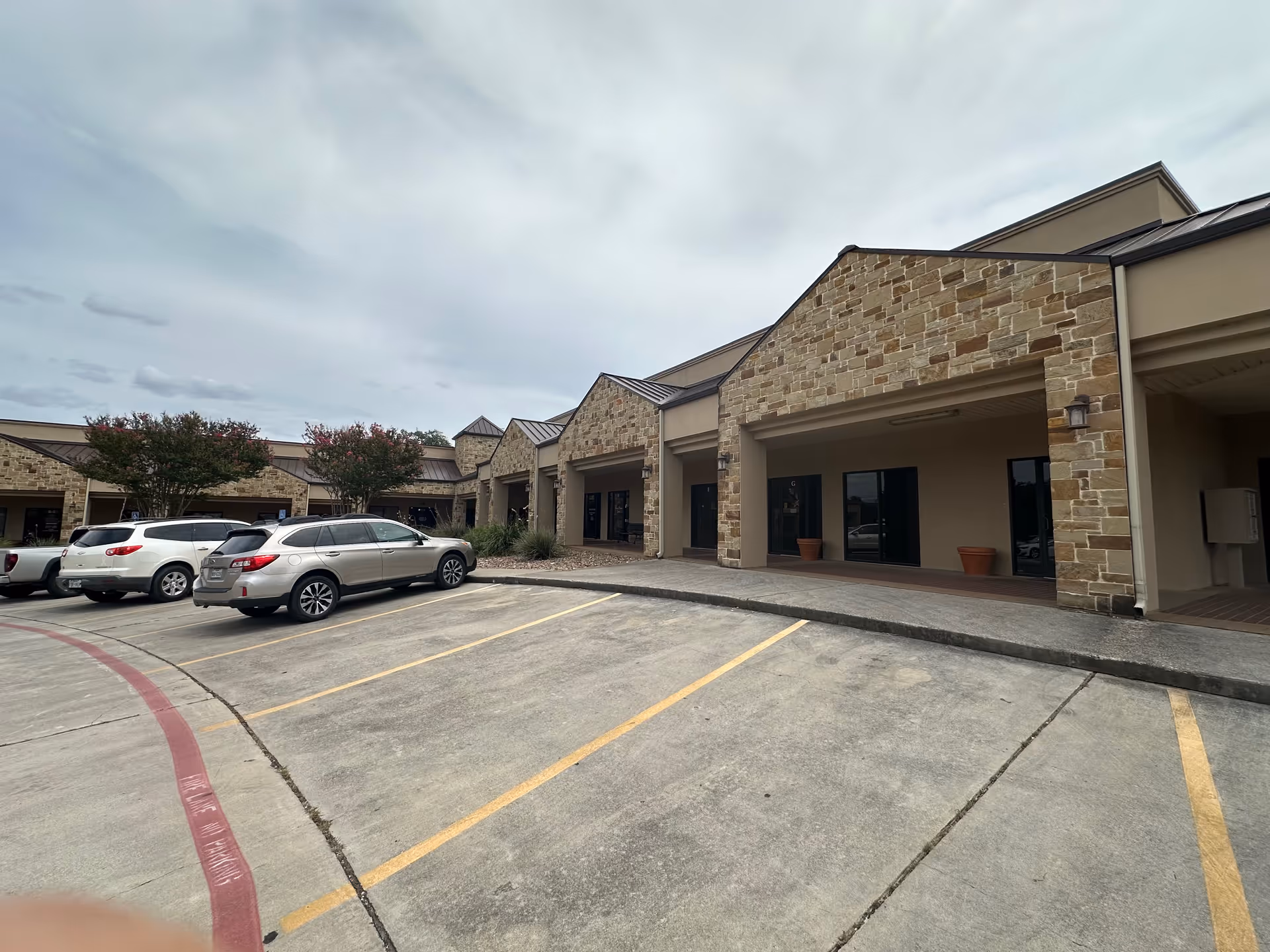 Exterior of Visiting Angels senior home care facility with a parking lot.