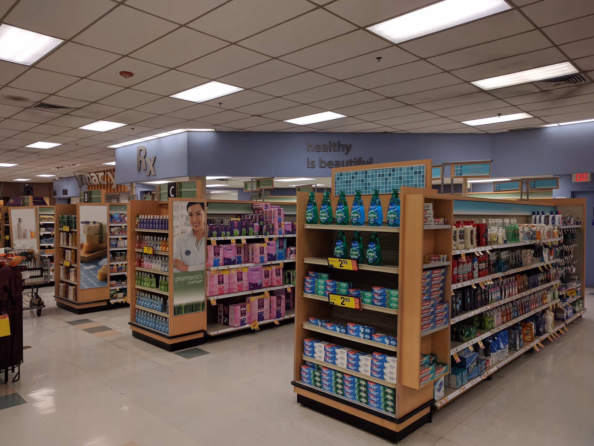 Interior of a Kroger Pharmacy aisle with shelves of medications and health items