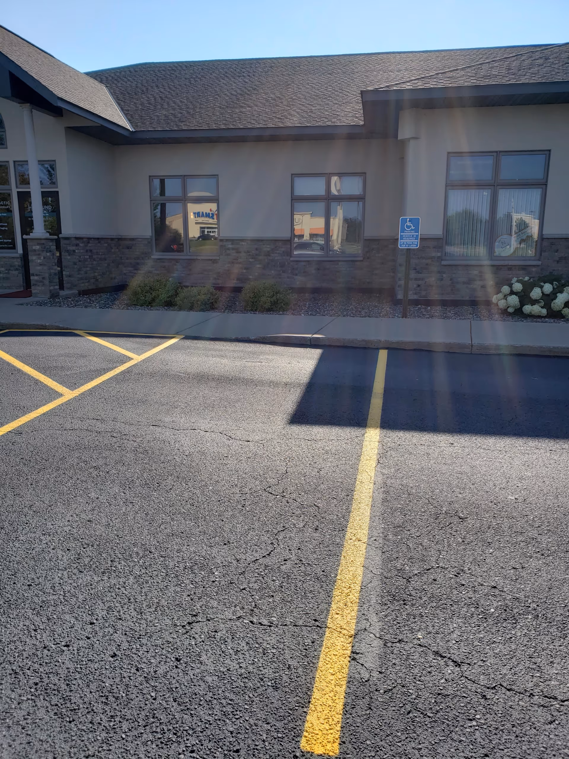 Exterior of St. Croix Hospice building with parking lot and handicap sign