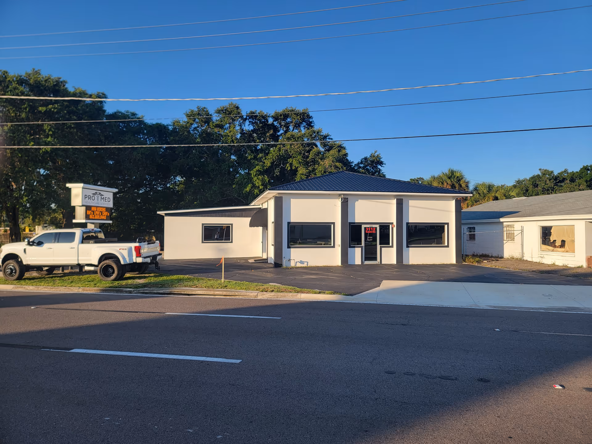 Exterior of Pro Med Healthcare Services building with a white pickup truck nearby