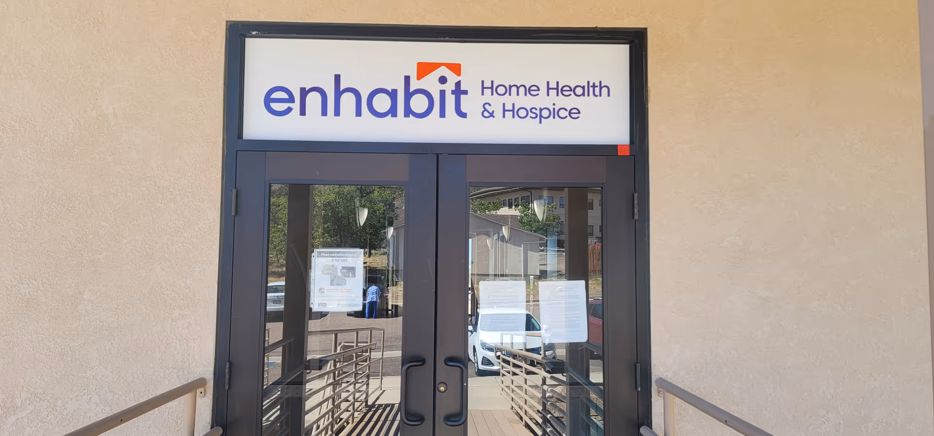 Double glass doors with Enhabit Home Health & Hospice sign above the entrance.