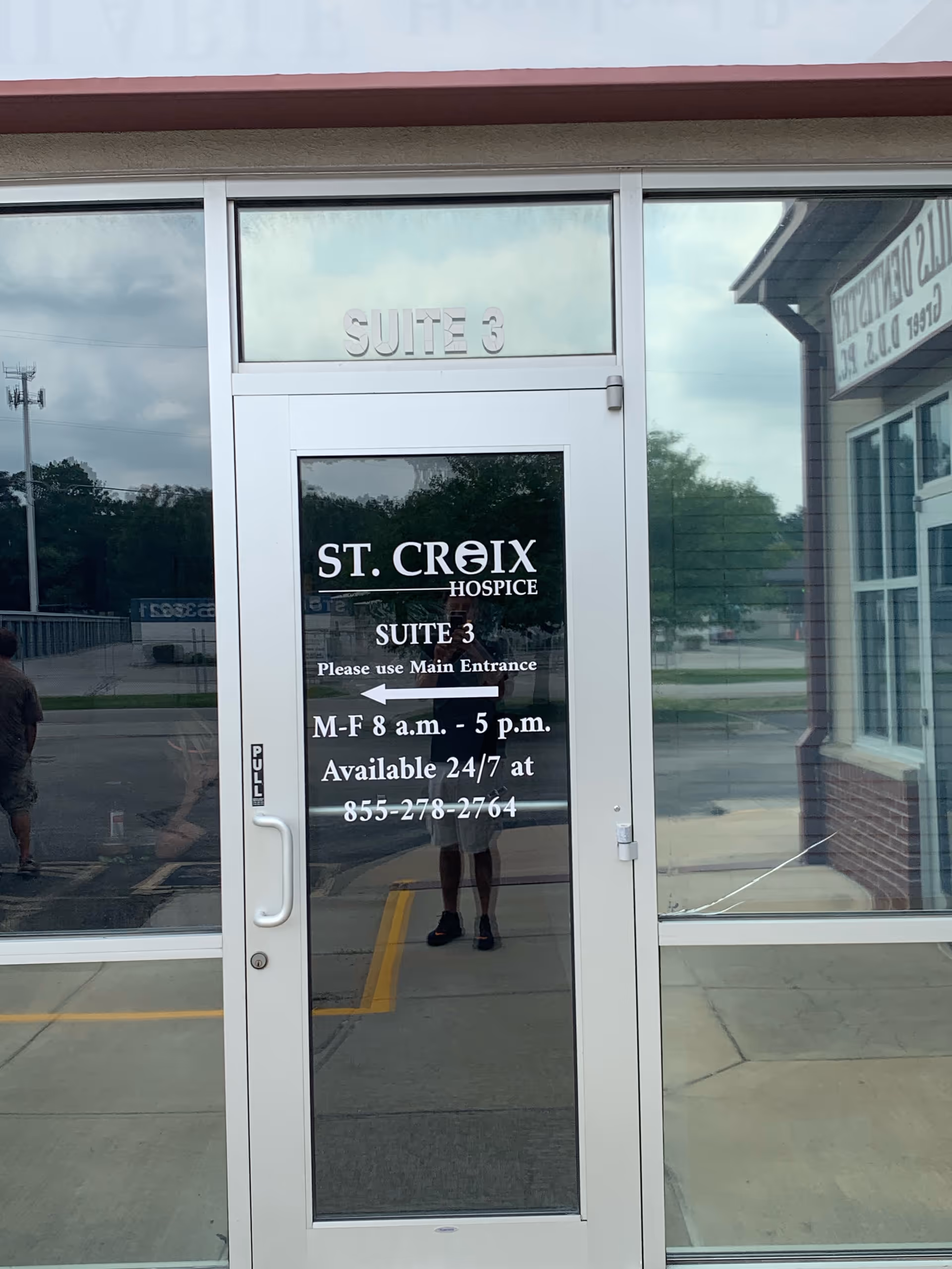 Glass entrance door for St. Croix Hospice, Suite 3, with hours and directions.