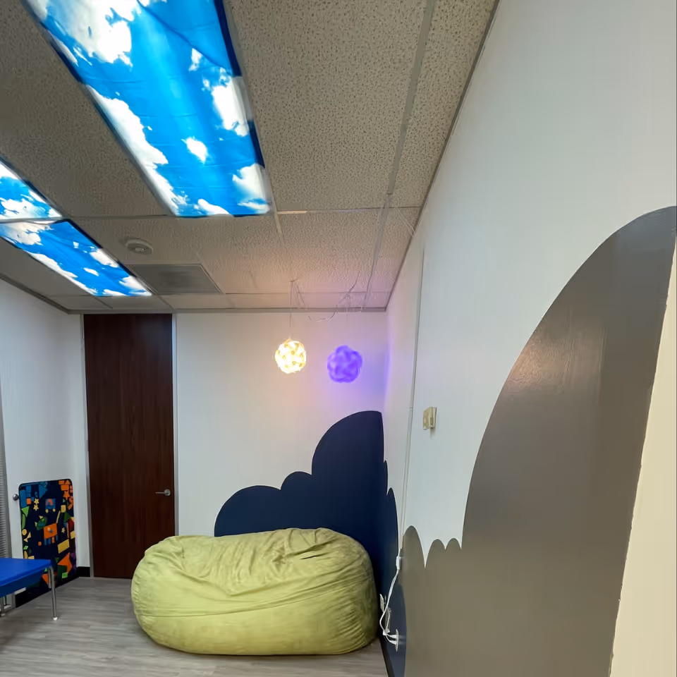 Bean bag chair in a whimsical interior room with cloud-pattern ceiling lights