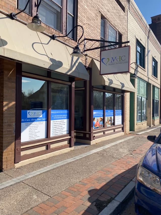 Exterior view of Marks Home Care Agency storefront with blue signs and windows.