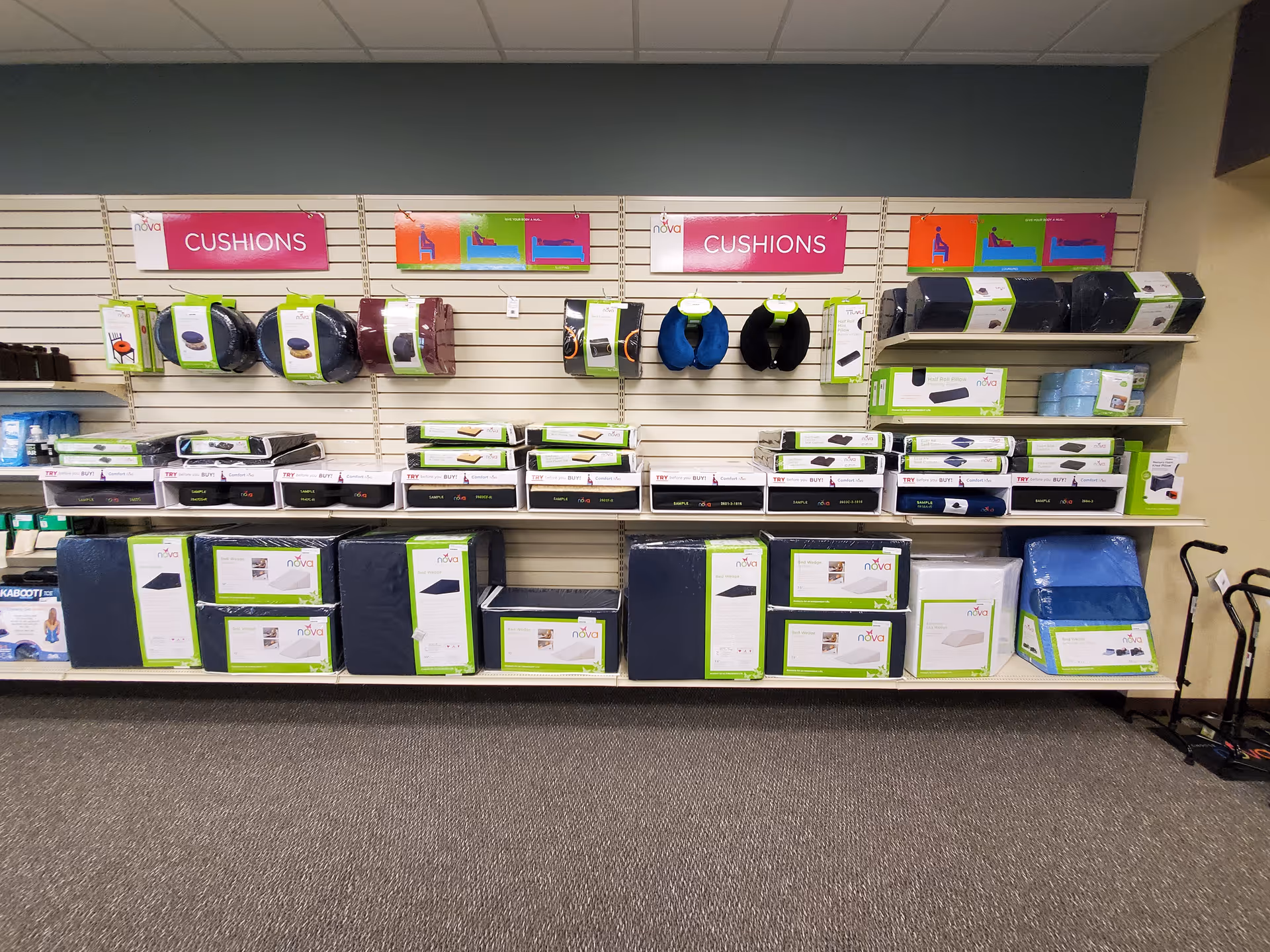 Store display of cushions and medical aids on a wall shelf.